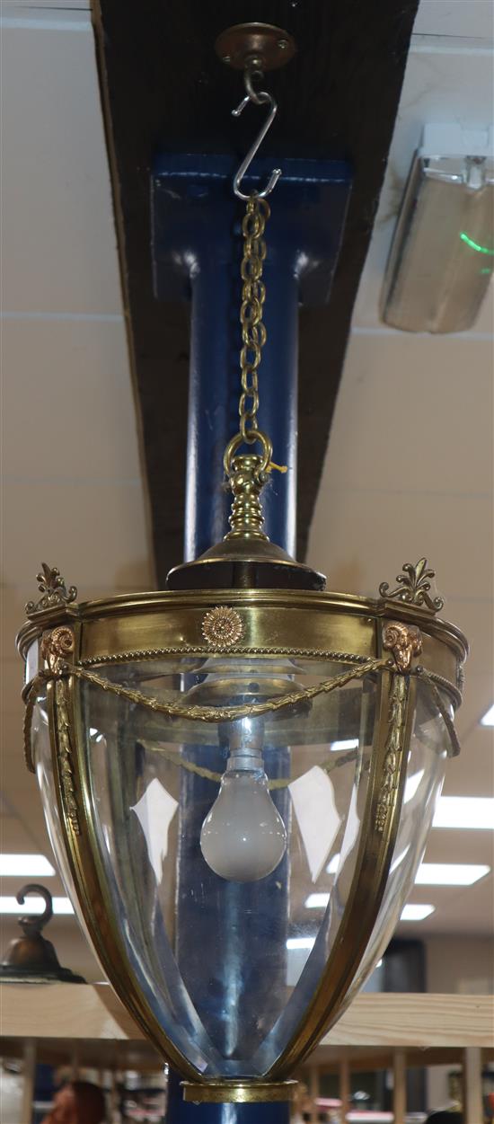 An Edwardian Adam design brass four glass hall lantern, with ram head mounts